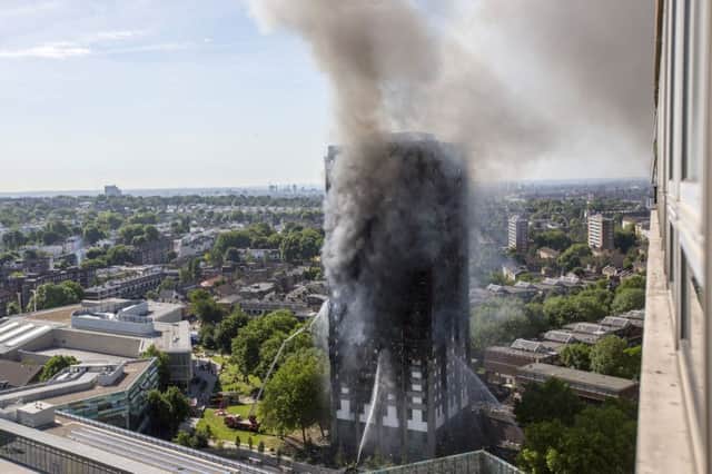 Smoke billows from a fire that has engulfed the 24-storey Grenfell Tower in west London.  PRESS ASSOCIATION Photo.