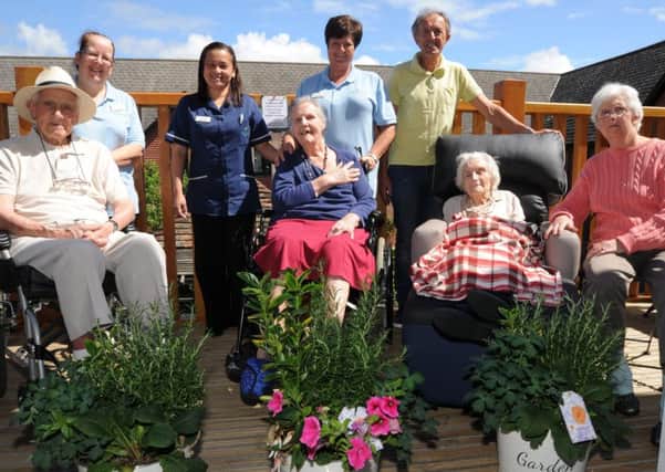 Longueville Care Home , presentation of flower pots for their new balcony.  Residents Albert Godley, Angela Talpede, June Bryant and Queenie Challis with Deputy Manager Margery Dino,  activity co-ordinators Claire Challis and Karina Dunn and event organiser Phil Smart. EMN-170530-145906009