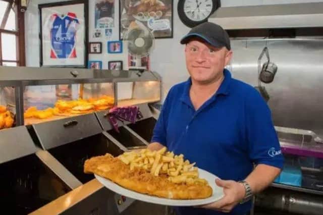 John Haggerston, 37, the owner of Casey's Fish Shop. Casey's serves what they claim to be the UK's biggest fish and chips, consisting of a huge side of battered fish, a massive portion of chips, four sides and a bread bap. Pic Benjamin Paul / SWNS.com