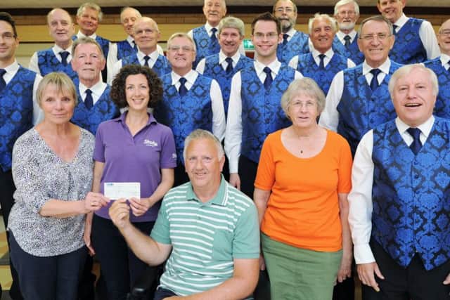 Halina Gould, Hannah Rushton, Andy Hull and Polly Hull from the Stroke Association receive a cheque from Alan Lund and his Hereward Harmony Singers at Orton Wistow community centre. EMN-170616-091731009