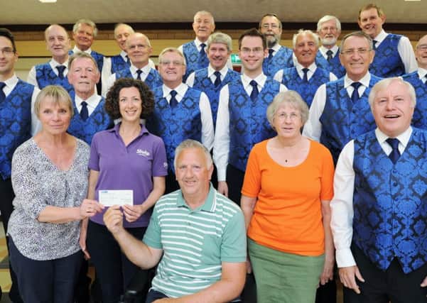 Halina Gould, Hannah Rushton, Andy Hull and Polly Hull from the Stroke Association receive a cheque from Alan Lund and his Hereward Harmony Singers at Orton Wistow community centre. EMN-170616-091731009
