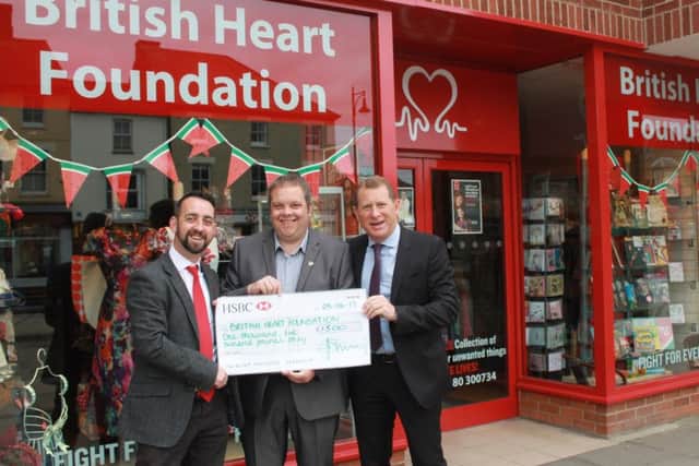 Representatives of Mick George present £1,500 to the British Heart Foundation, in Rivergate, in Peterborough.