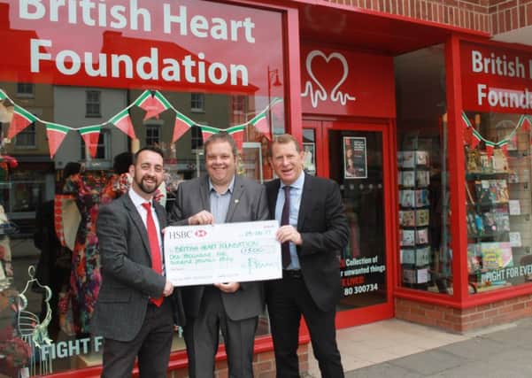 Representatives of Mick George present Â£1,500 to the British Heart Foundation, in Rivergate, in Peterborough.