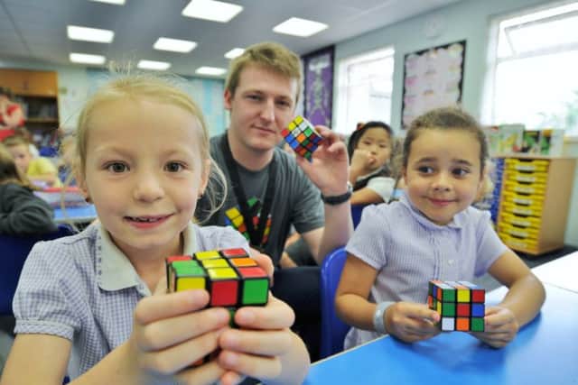 Jessica Homewood and Maisie Ludlow, pupils at Winyates primary school who won a Rubik's cube competition to have speedcuber Laurence Livsey in school to present each classmember with a cube EMN-170622-204216009