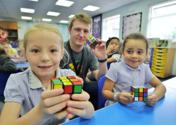 Jessica Homewood and Maisie Ludlow, pupils at Winyates primary school  who won a Rubik's cube competition to have speedcuber Laurence Livsey in school to present each classmember with a cube EMN-170622-204216009