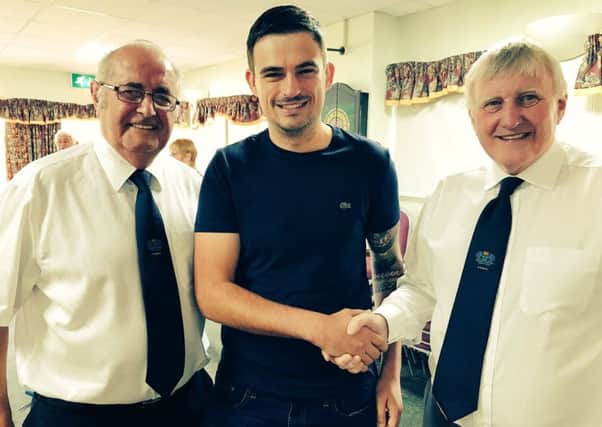 Posh Deaf club official Alex Tovey is flanked by Peterborough Sunday Morning League chairman Fred Johnson (left0 and League president David Oxer (right).