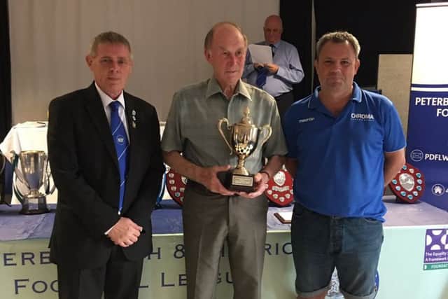 Trevor Bass (centre) collects his outstanding contribution to football award from Peterborough League chairman Clive Wilson (left) and Mark Wilson from league sponsors Chromasport.