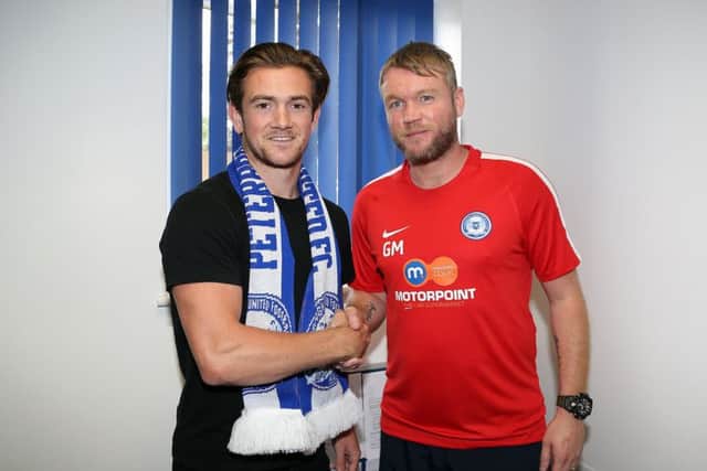 New signing Jack Marriott (left) with Posh manager Grant McCann. Photo: Joe Dent/theposh.com.