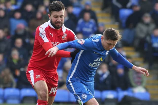 Michael Doughty (left) playing for Swindon Town against Posh.