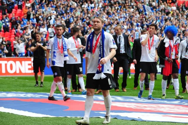 Current Posh manager Grant McCcann savours the Football League Trophy Final win over Chesterfield at Wembley.