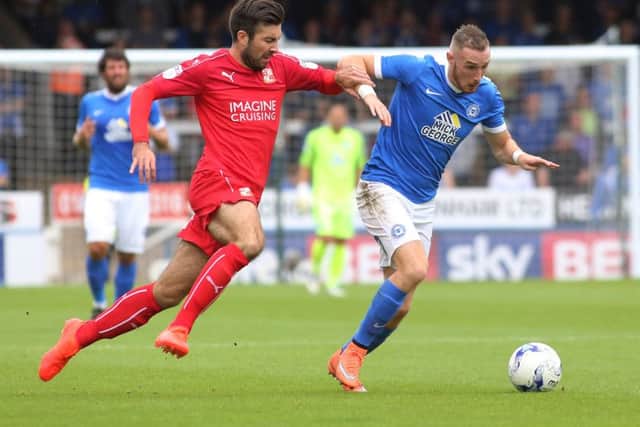 New signing Michael Doughty (left) playing for Swindon against Posh last season.