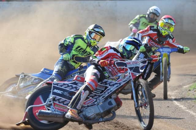 Heat two action from Panthers v Ipswich involving home riders Paul Starke (red helmet) and Ulrich Ostergaard (blue). Photo: David Lowndes.