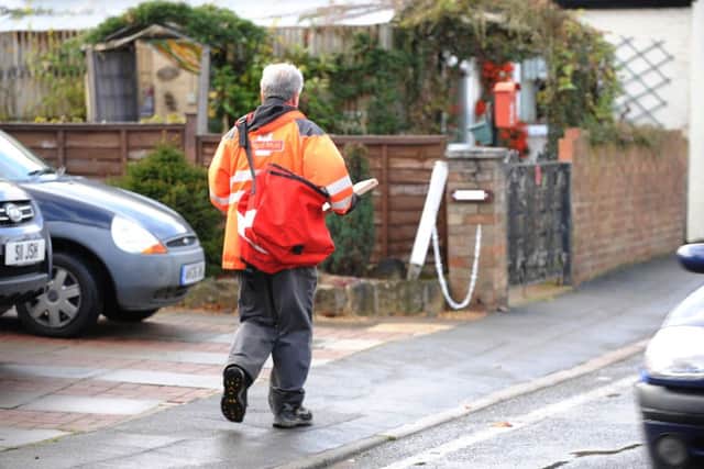 Royal Mail postman in North Street, Stanground ENGANL00120130908172844