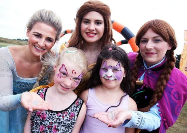 From left, Elsa, Zofia (5), Belle, Gabrielle (8) and Anna (Disney characters) at the family fun day.  Â© Tim George/ UNP 0845 600 7737

36961