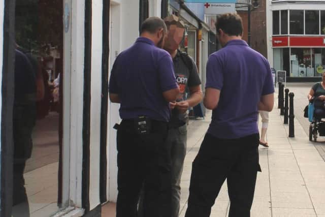A man gets issued with a Fixed Penalty Notice in Wisbech town centre for dropping litter