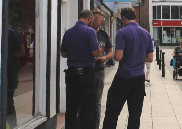 A man gets issued with a Fixed Penalty Notice in Wisbech town centre for dropping litter