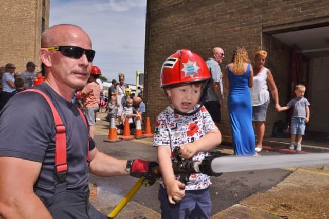 Dogsthorpe fire station annual open day. Firefighter   Barry Boreham with Teddy Sampson (3) EMN-170807-175251009