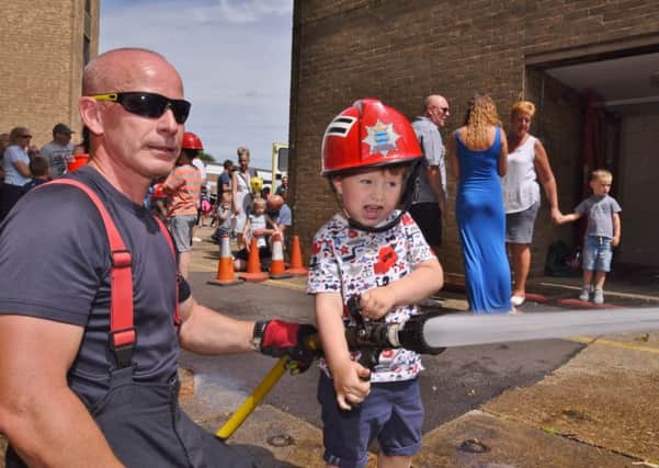 Dogsthorpe fire station annual open day. Firefighter   Barry Boreham with Teddy Sampson (3) EMN-170807-175251009