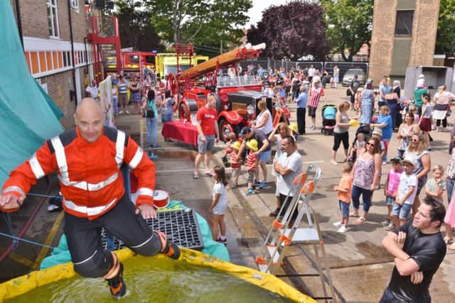 Dogsthorpe fire station annual open day. Firefighter  Darren Edwards gets a dunking EMN-170807-175303009