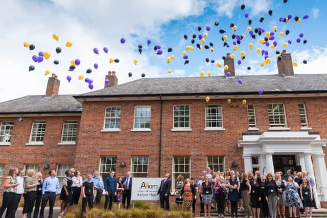 Staff at Axiom Housing celebrate the start of a new era.