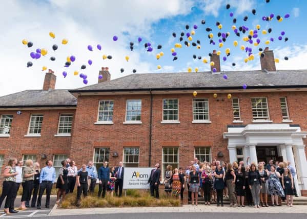 Staff at Axiom Housing celebrate the start of a new era.