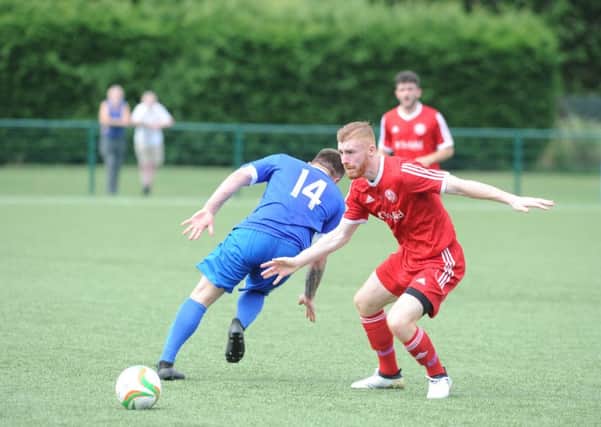 Action from Yaxley's 3-0 friendly win over Peterborough Sports (red). Photo: David Lowndes.
