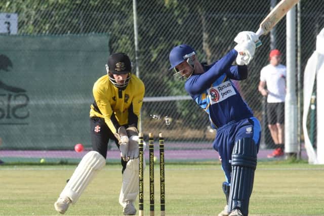 Bourne captain Pete Morgan is bowled by Hasan Azad in the Jaidka Cup Final. The Peterborough Town wicket-keeper is Chris Milner. Photo; David Lowndes.
