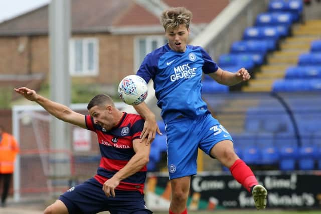 Posh youngster Sam Cartwright challenges Conor Washington of QPR. Photo: Joe Dent/theposh.com.
