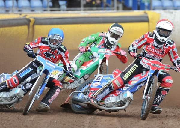 Action from heat two of Panthers v Redcar with Simon Lambert (red helmet) and Tom Bacon (blue) in action for the city side. Photo: David Lowndes.