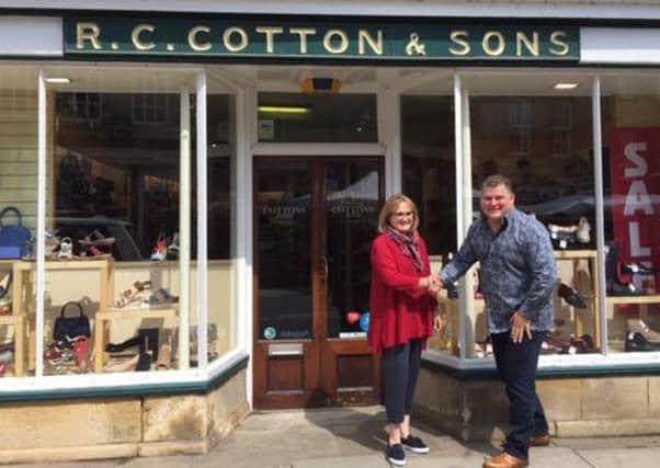 Anne Cotton and James North outside R C Cotton and Sons, in Market Place, Oundle.