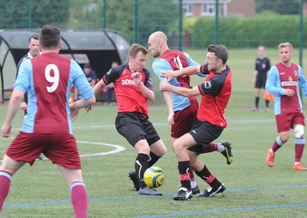 Action from Deeping Rangers' 2-1 friendly win at Netherton United (red). Photo: David Lowndes.