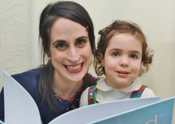 Childrens' author  Sayeh Stone at home with her daughter Soheyla (4) looking at her new book EMN-170220-193157009