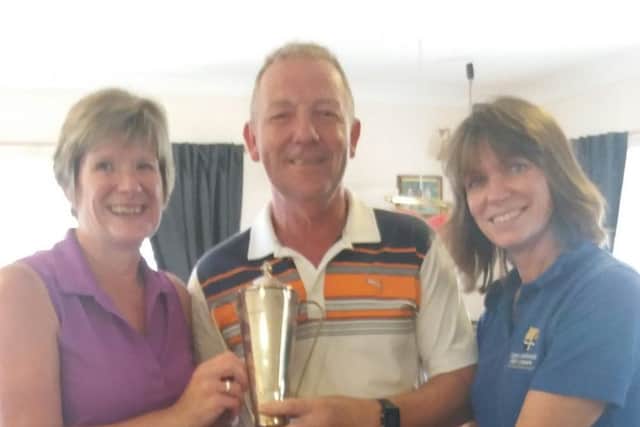Monkwise Mixed Pairs champions at Gedney Hill, Chris Bennett and Nick Markillie being, are presented with the trophy by Lady Captain Lynn Exley.