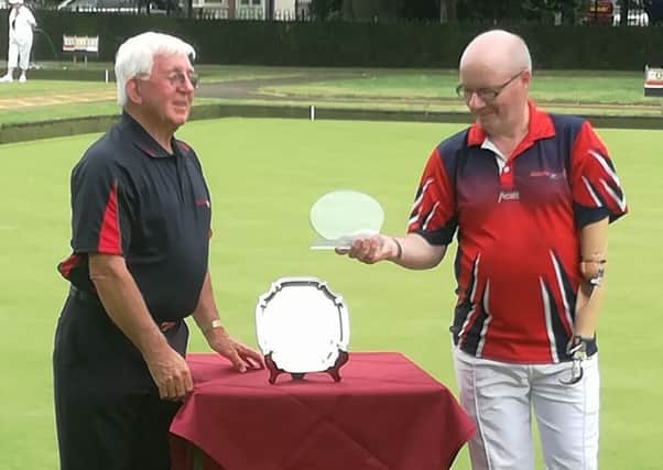 Mike Robertson (right) collects the Disability Bowls England Open Singles title prize.
