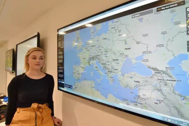 Senior duty manager Emily Gibson surveys a map showing locations of Thomas Cook flights at the Thomas Cook Duty Office in Peterborough. EMN-170905-233623009