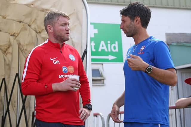 Posh manager Grant McCann with Lincoln manager Danny Cowley before the game at Sincil Bank. Photo: Joe Dent/theposh.com.