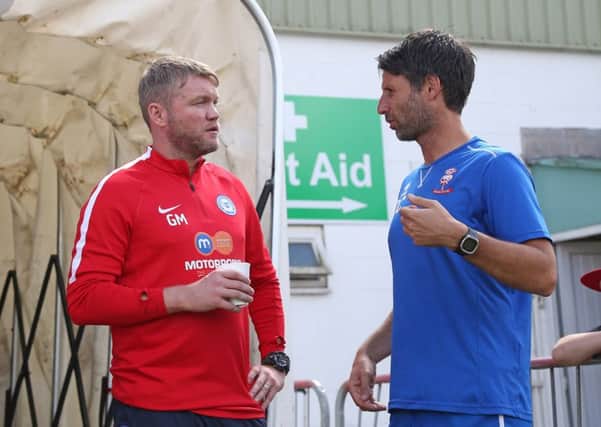 Posh manager Grant McCann with Lincoln manager Danny Cowley before the game at Sincil Bank. Photo: Joe Dent/theposh.com.