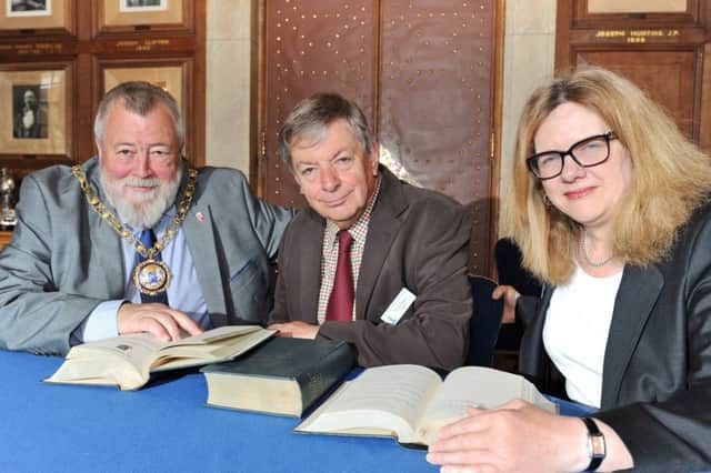Mayor of Peterborough Coun. John Fox with  Trevor Pearce (chairman) and Julie Nicholson (secretary) of Peterborough  History Society receiving City of Peterborough Council Minutes books from 1922-1979 from the City Council. EMN-170724-143918009