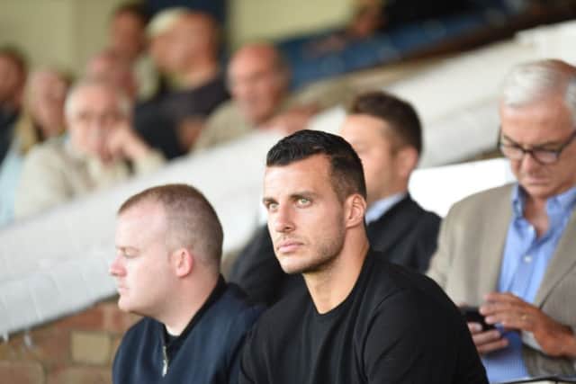 New Posh signing Steven Taylor watches the match against Wolves. Photo: David Lowndes.