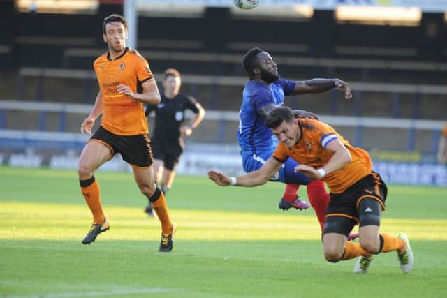 Posh striker Junior Morias is sent tumbling in the friendly against Wolves. Photo: David Lowndes.