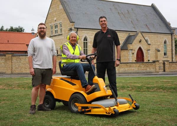 Peter Thompson the Chair of the DRA (on the mower), Cllr Craig Rudd of Bretton Parish Council (in shorts) and Tom Calton, Managing director of the Peterborough Mower and Groundcare Centre (in black).