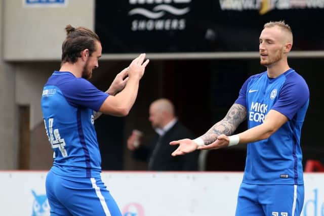Marcus Maddison celebrates his Posh goal at Cheltenham with hat-trick hero Jack Marriott. Photo: Joe Dent/theposh.com.