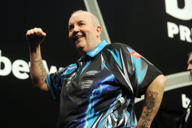 Phil Taylor celebrates another win.
