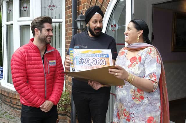 Del Singh and Wife Judi are given their prize by Peoples Postcode Lottery Ambassador, Matt Johnson