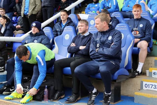David Oldfield (right) on the Posh bench with manager Grant McCann.