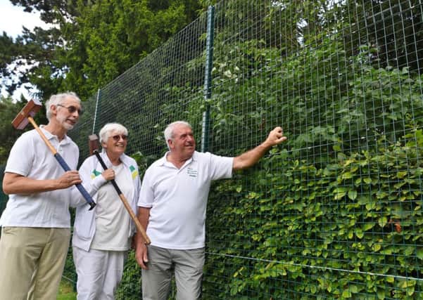 New fencing installed at  Central Park around the bowls and croquet greens. Graham Harris,  Roz Wright and Phillip Makepeace inspect the work. EMN-170108-124130009