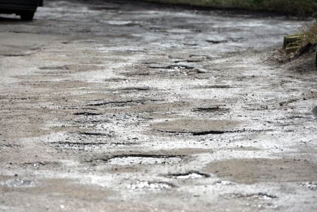 A pothole strewn road