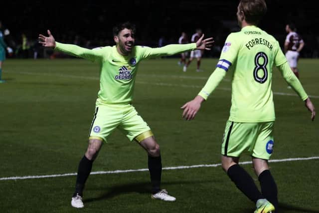 Michael Smith congratulates Chris Forrester after his winning goal for Posh at Sixfields.