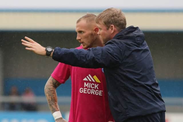 Posh manager Grant McCann issues intstructions to star man Marcus Maddison.