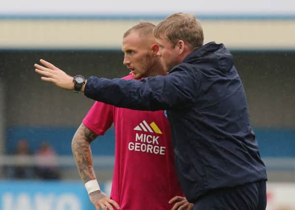 Posh manager Grant McCann issues intstructions to star man Marcus Maddison.